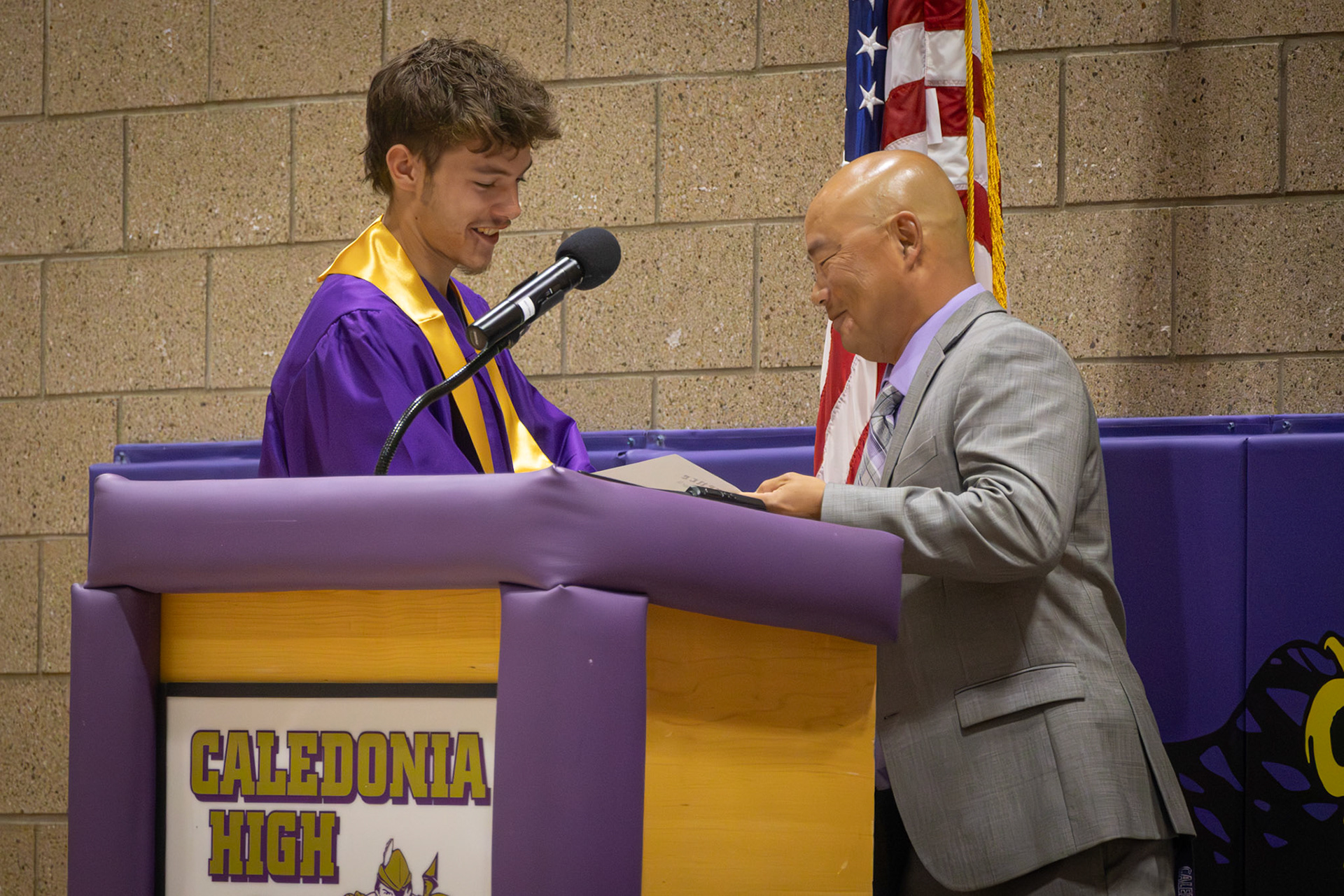 Noah Johnston accepts the male Athlete of the Year award from Athletic Director Phil Miedema. (Photo by Emma Garza)
