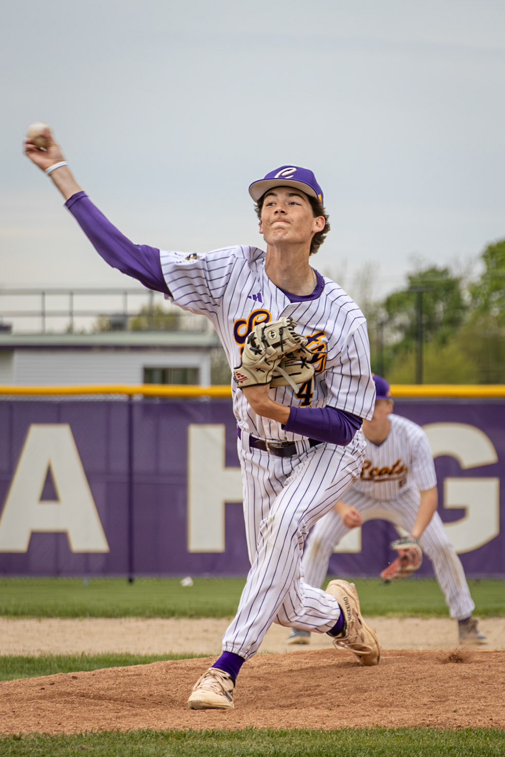 Senior Gabe Trudeau delivers a pitch as the Scots secure a win over Muskegon. (Photo by Vivian Hoffman)
