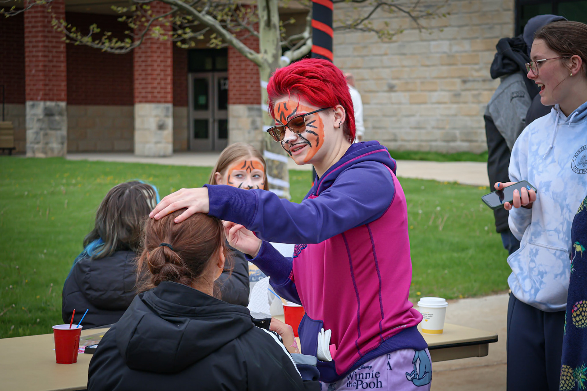 Sophie Grajewski brings smiles to her peers by painting faces and sharing her face painting skills. (Photo by Brianna Severson)