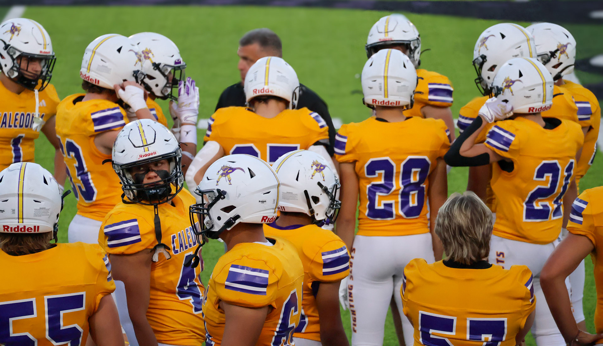 Varsity players joke and prepare on the sideline before the Homecoming game.(Photo by Brianna Severson)