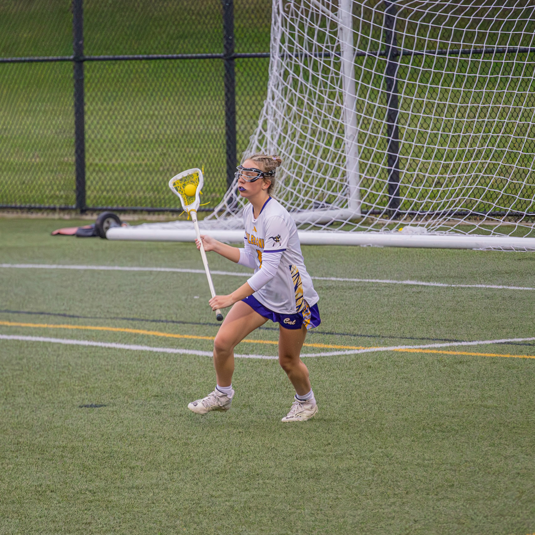 Caelyn Crocker gears up to dodge past defenders and drive into the offensive side. (Photo by Abby Skibinski)
