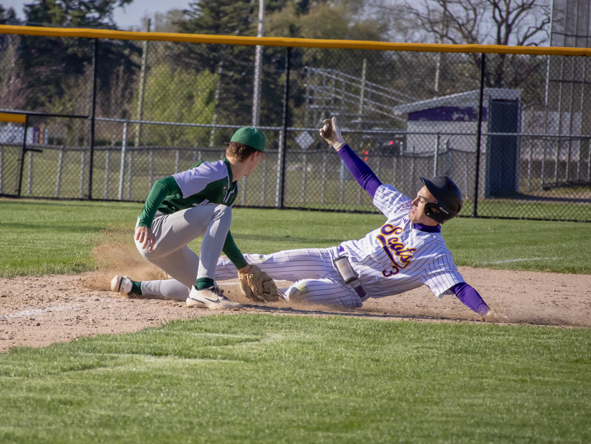 Dodging the third baseman's glove, Jimmy Holmes slides after an amazing hit and a triple. (Photo by Ella-Grace Wickens)