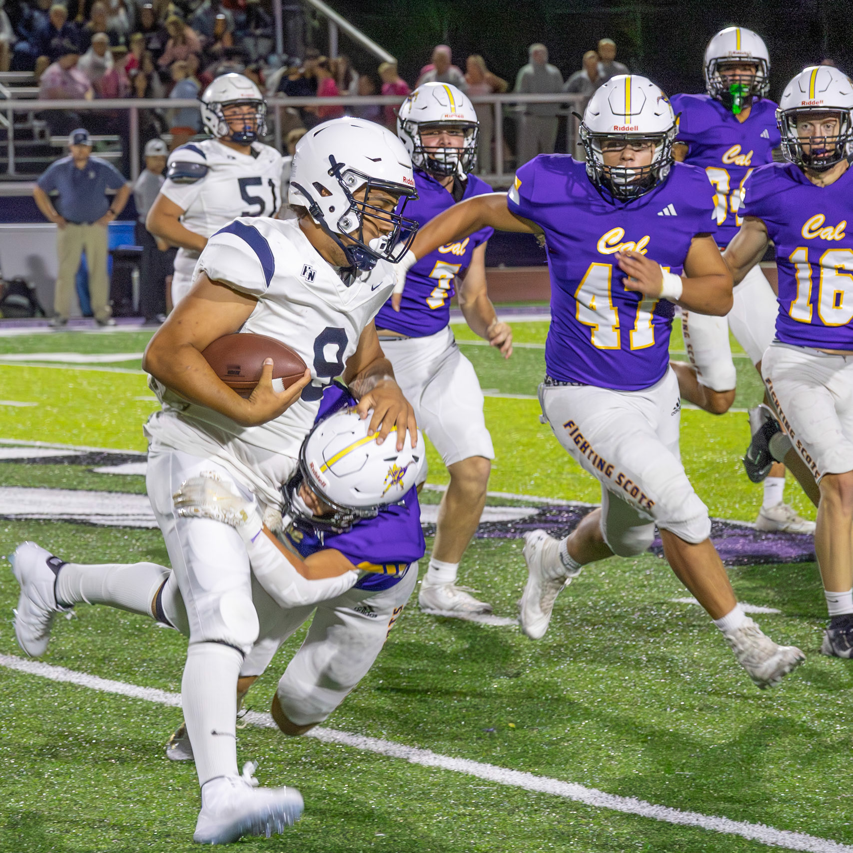 Carter Berends, Caledonia cornerback, brings down the quarterback with a strong tackle to stop the play. (Photo by Egan Otto)