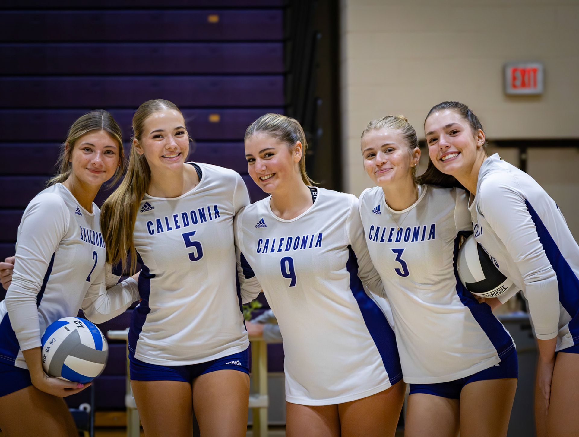 Kayla Briseno, Keira Paalman, Dylan Hilaski, Kayleigh Miersen, and Lydia Bell smile before their victorious game against the Reeths-Puffer Rockets. (Photo by Khloe Lowande)
