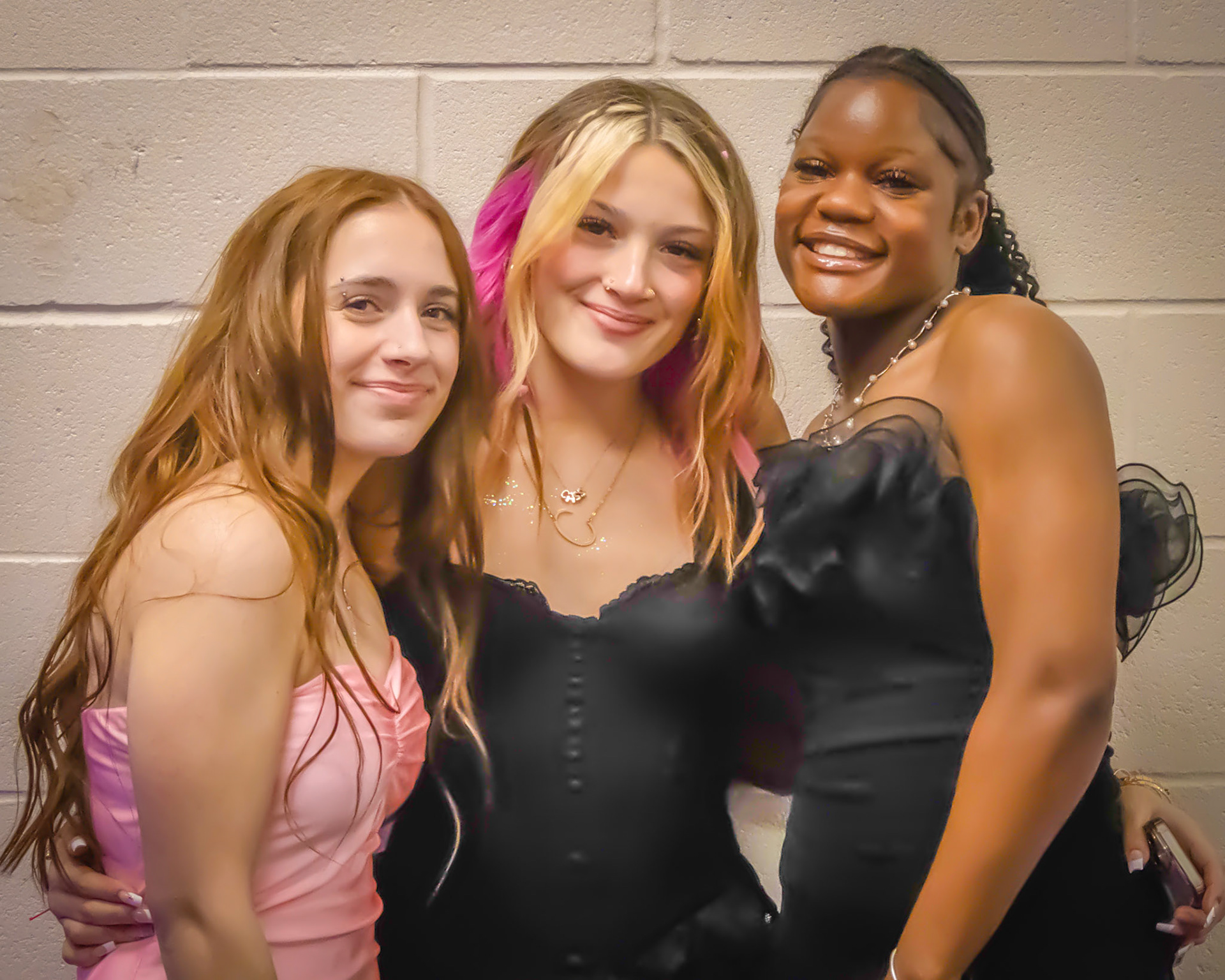Grouping together for a quick photo: Cassidy Collins, AhNya Pittman, and Alyson Minton. (Photo by Ella-Grace Wickens)