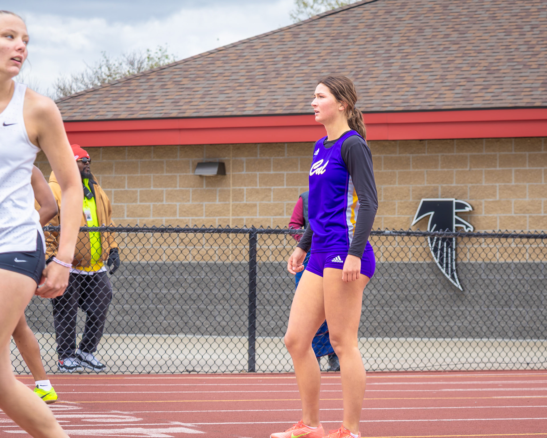 Holding her breath at the finish — Isla Sheely watches her teammate bring it home as the 4x100 squad secures a new school record. (Photo by Mya VanderZwaag)