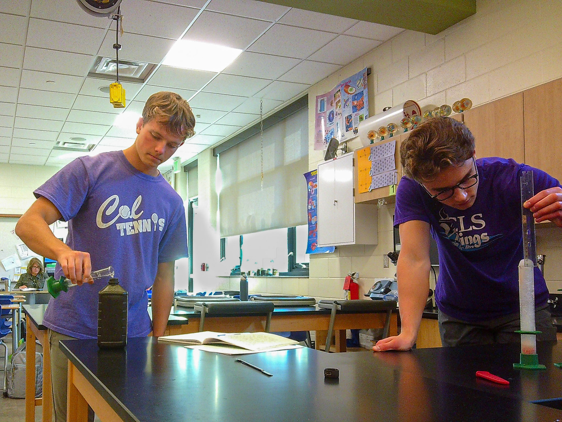 Seniors Caleb Harrison and Ethan Snapper observe how adding Hydrogen Peroxide to Beef Liver will cause a reaction. (Photo by Avarey Lippert)
