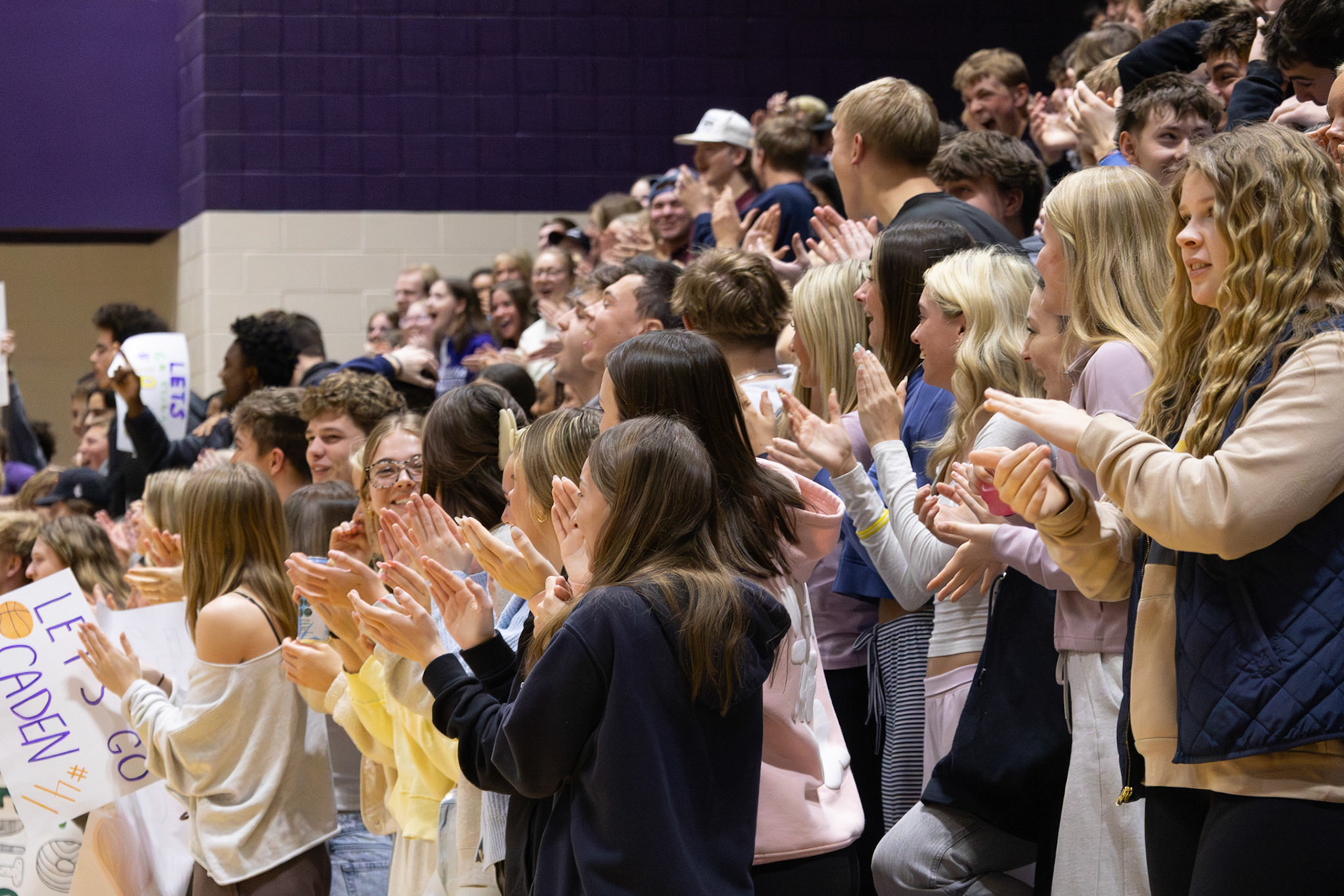 With every shot made, juniors and seniors show their support for Jenison and Caledonia Unified players through clapping and cheers. (Photo by Abby Skibinski)