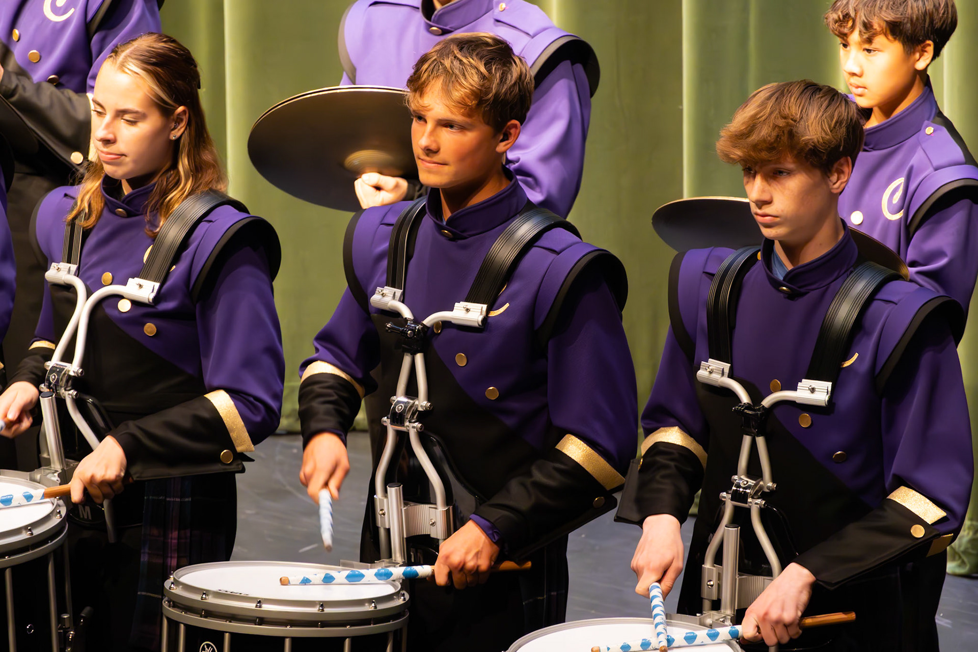 A trio of talent. Larissa Dudicz, Caleb Harrison, and Owen Horton command the center of the percussion setup. (Photo by Molly Larson)