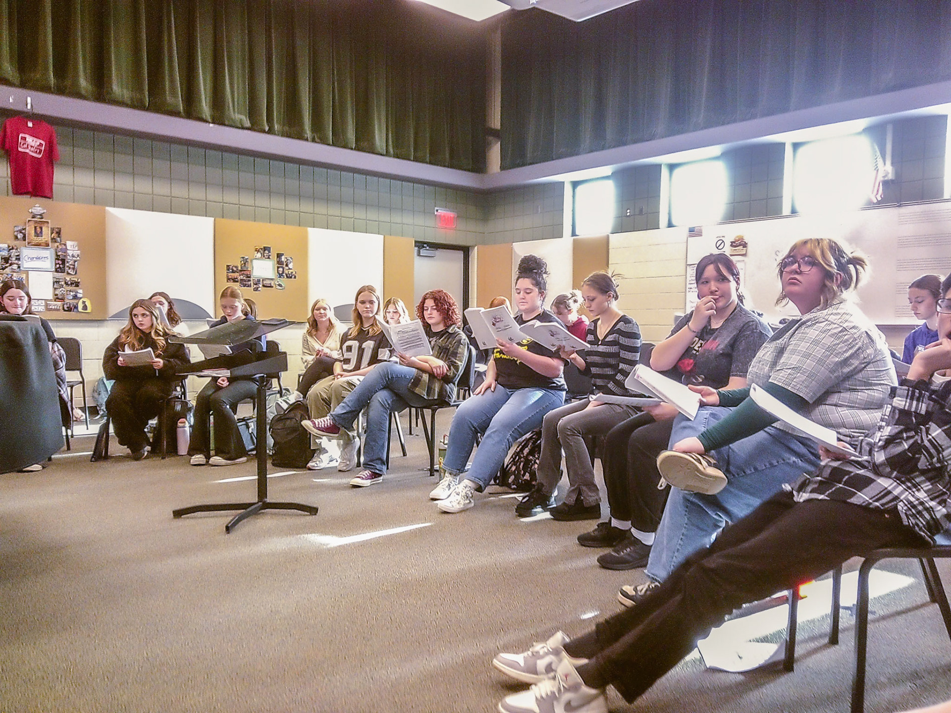 Abigail Wilkes, with Maggie Koopman, Ella Rigley and Arianna Gue, together rehearsing their music for Willy Wonka, the Musical. (Photo by Lucas Swartz)