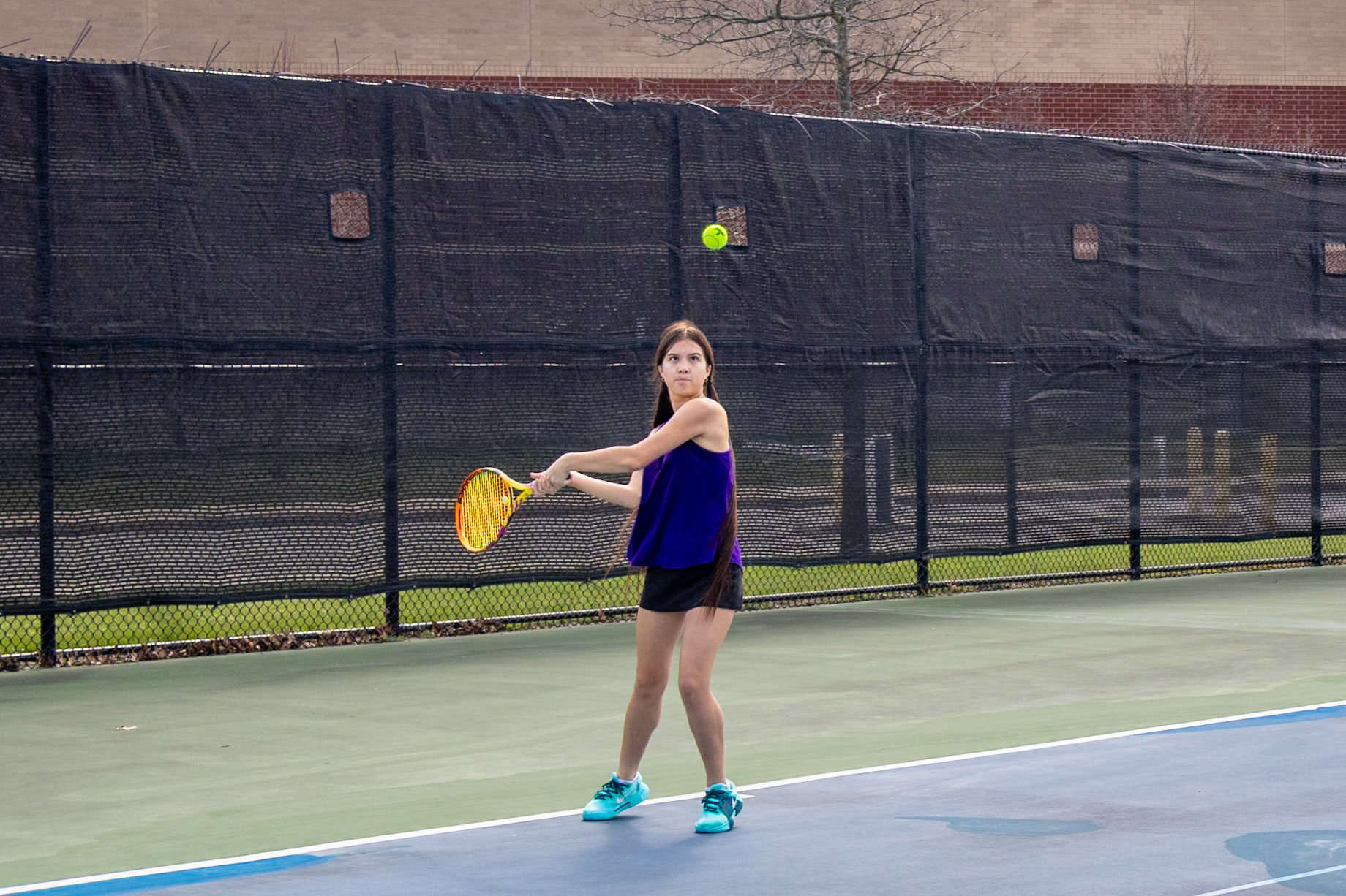 Audrey Duong is determined to win her match against Mona Shores. (Photo by Hailey Thayer)