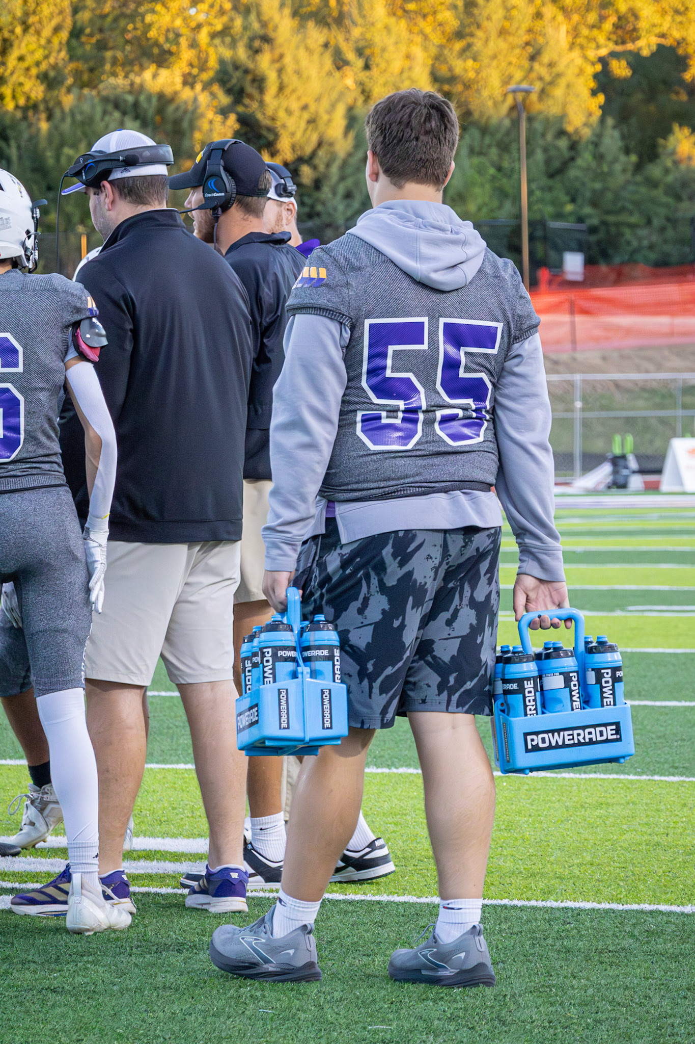 While recovering from an injury, Tyler Menninga helps keep his team hydrated because, as he says, "It’s important to support your team even from the sidelines.” (Photo by Sydney Palmer)