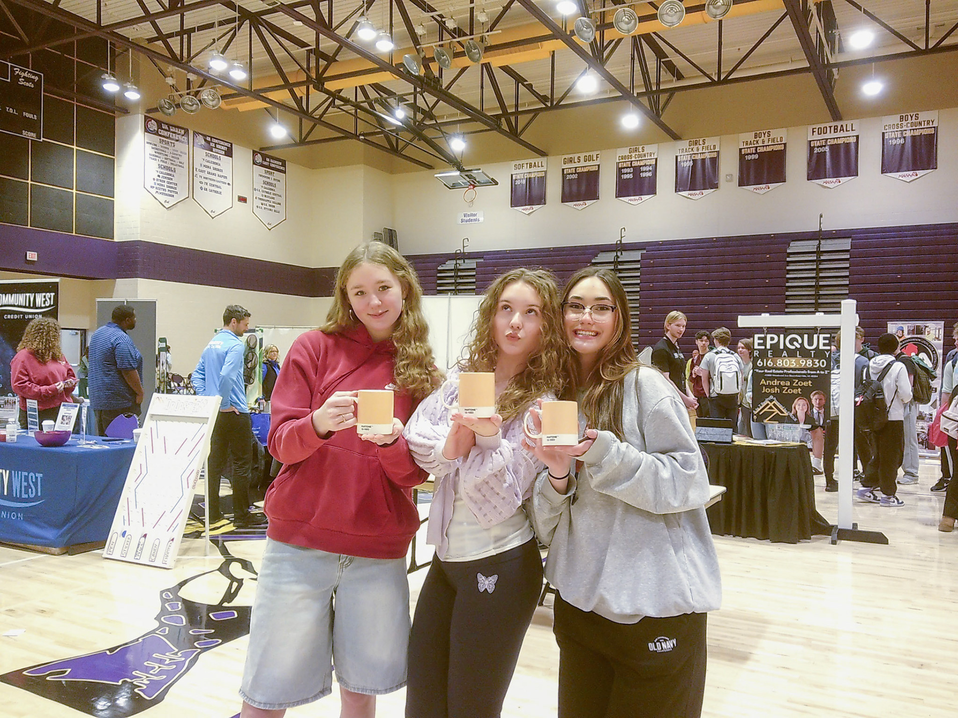 Savannah Robinson, Keira Marshall, and Leila DeOliveira-Terzic show off their newly won peach Pantone mugs. (Photo by Keira Marshall)