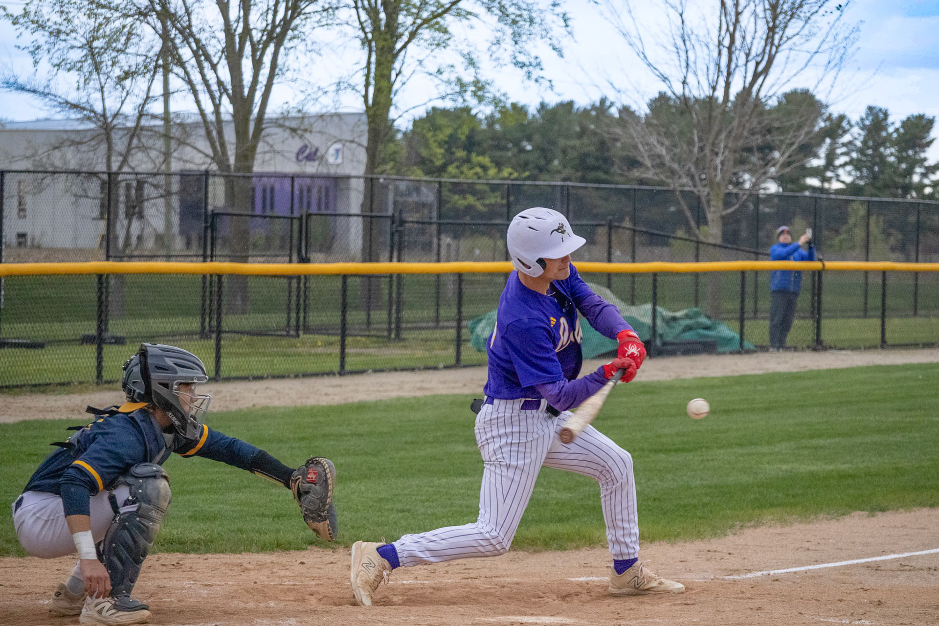 Swinging at his second pitch, Ethan Sova hits the ball right in the center of the barrell launching into the field for a base hit. (Photo by Ella-Grace Wickens)