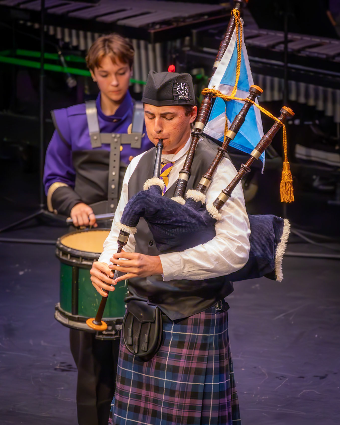 Gavin Senneker honors our tradition with a stirring solo on the bagpipes, a prelude to his fellow pipers joining the stage. (Photo by Molly Larson)