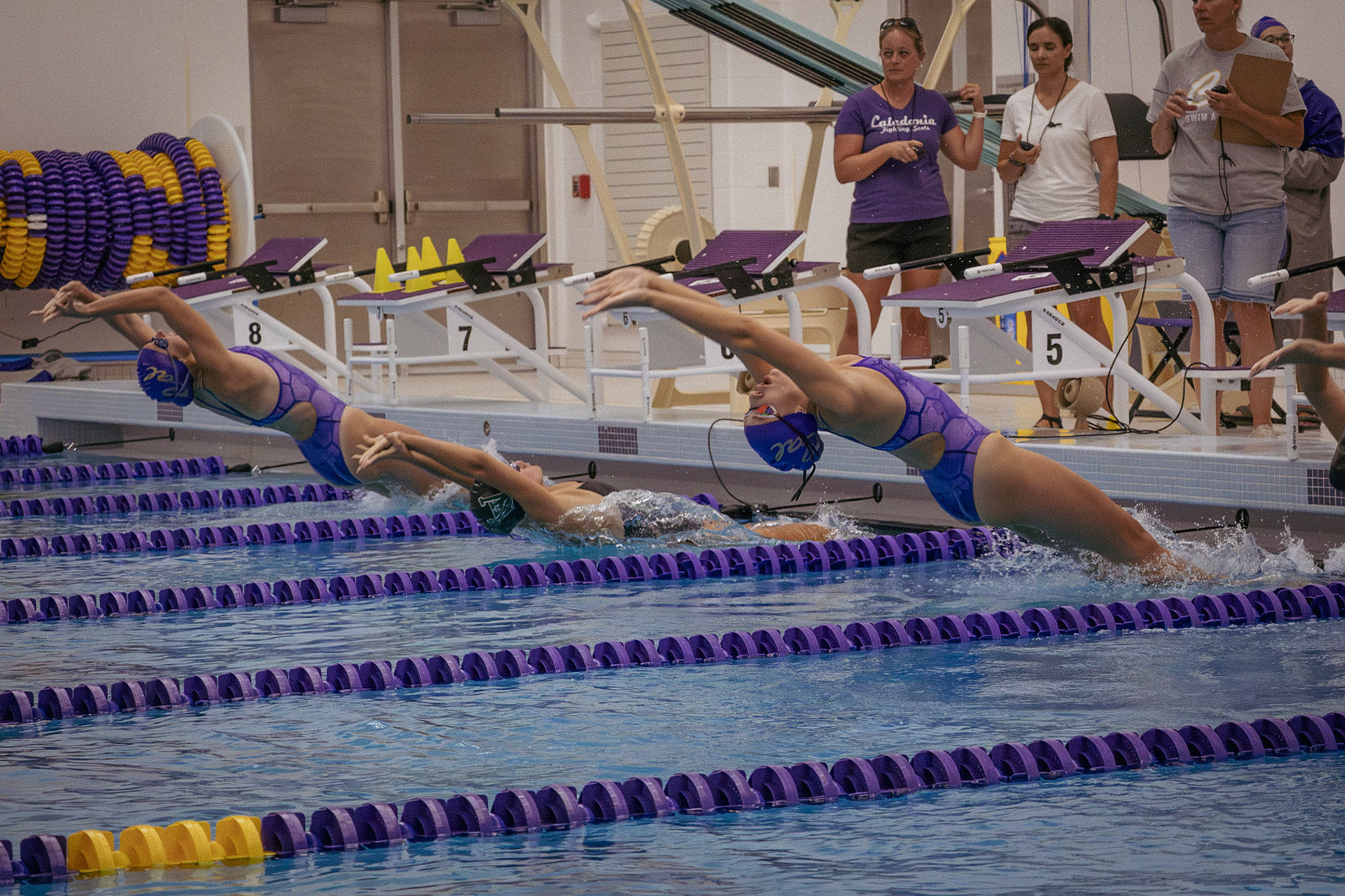 DRIVEN  At the sound of the buzzer, Sophie Gaylord and Aliya Van-Hofwegen (South Christian) push back from the wall to start the backstroke event against Wayland. (Photo by Abby Skibinski)