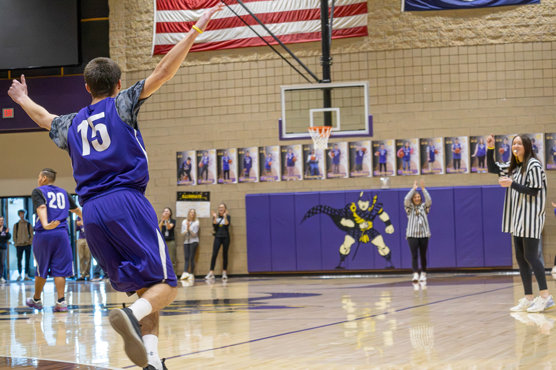 Josh Kietzman hits a last-second shot to end the game, then celebrates by running the court and rallying the crowd. (Photo by Abby Skibinski)