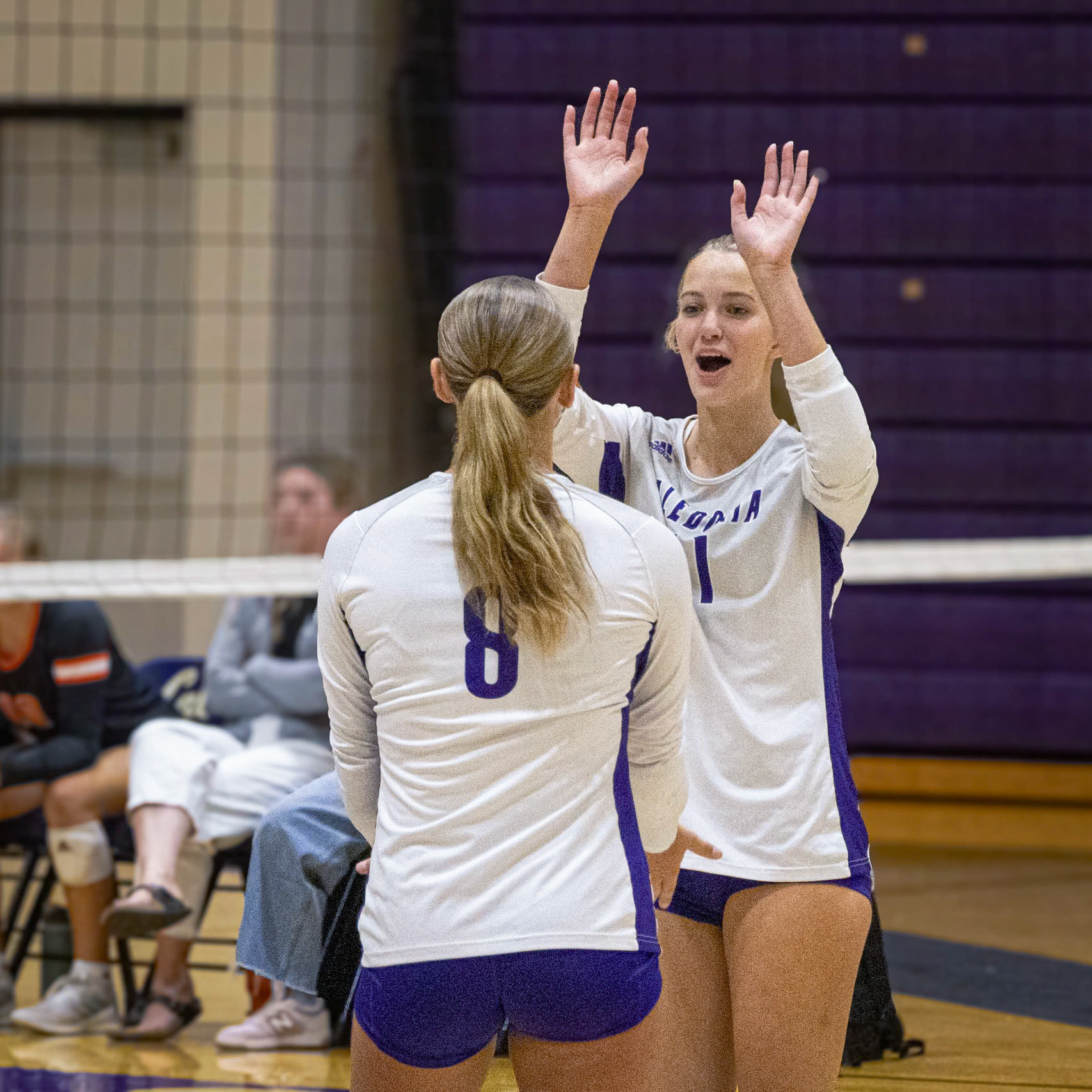 Senior Maggie Loomis with her teamate Sophmore Quinn Ziegler after gaining a point agasint the Byron Center Bulldogs. (Photo By Kortney Muller)
