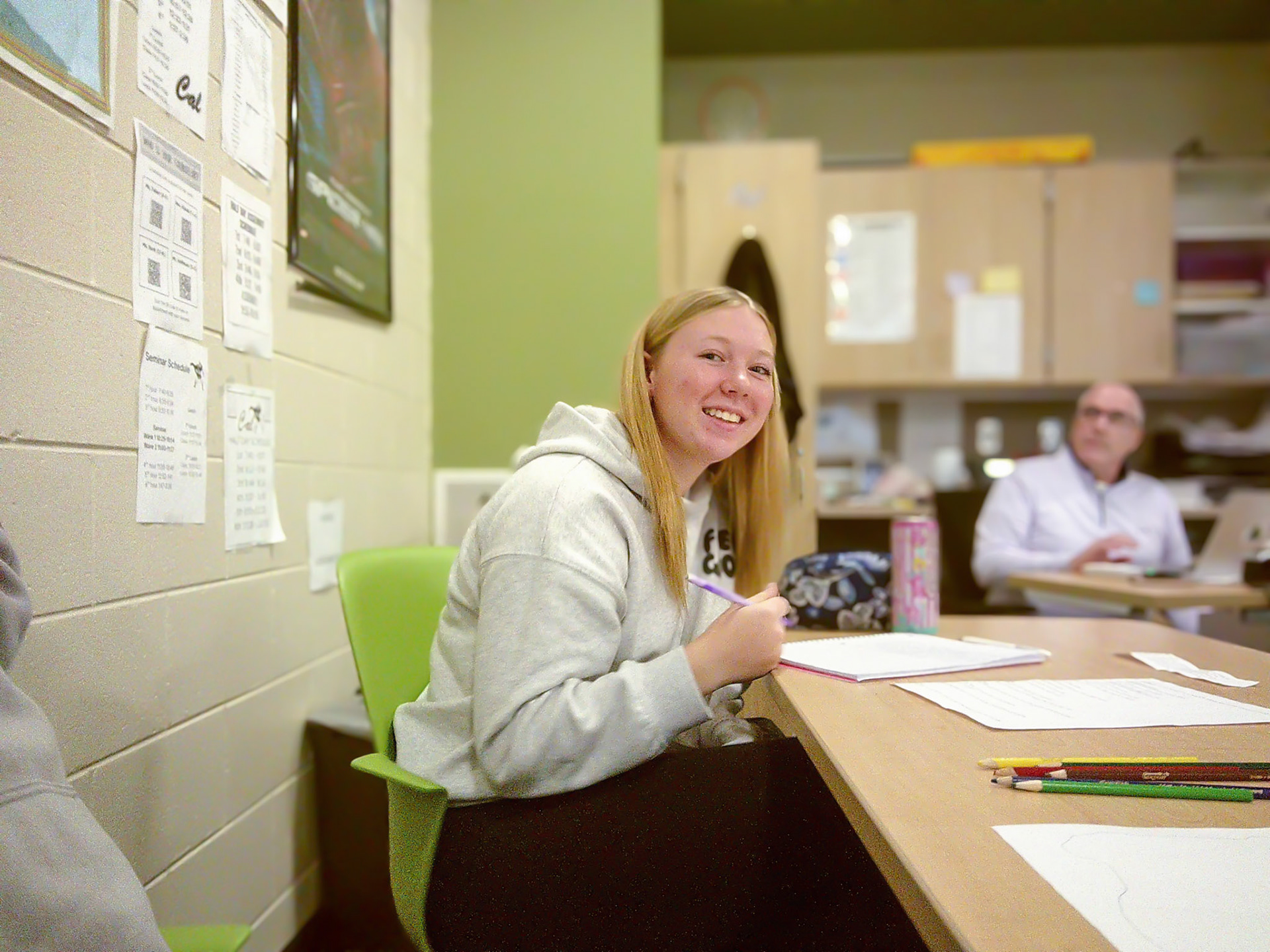 BRIGHT MIND Emily Walbeck stays focused in economics class, putting the finishing touches on a project with a smile. (Photo by Natalia Teneyuque)