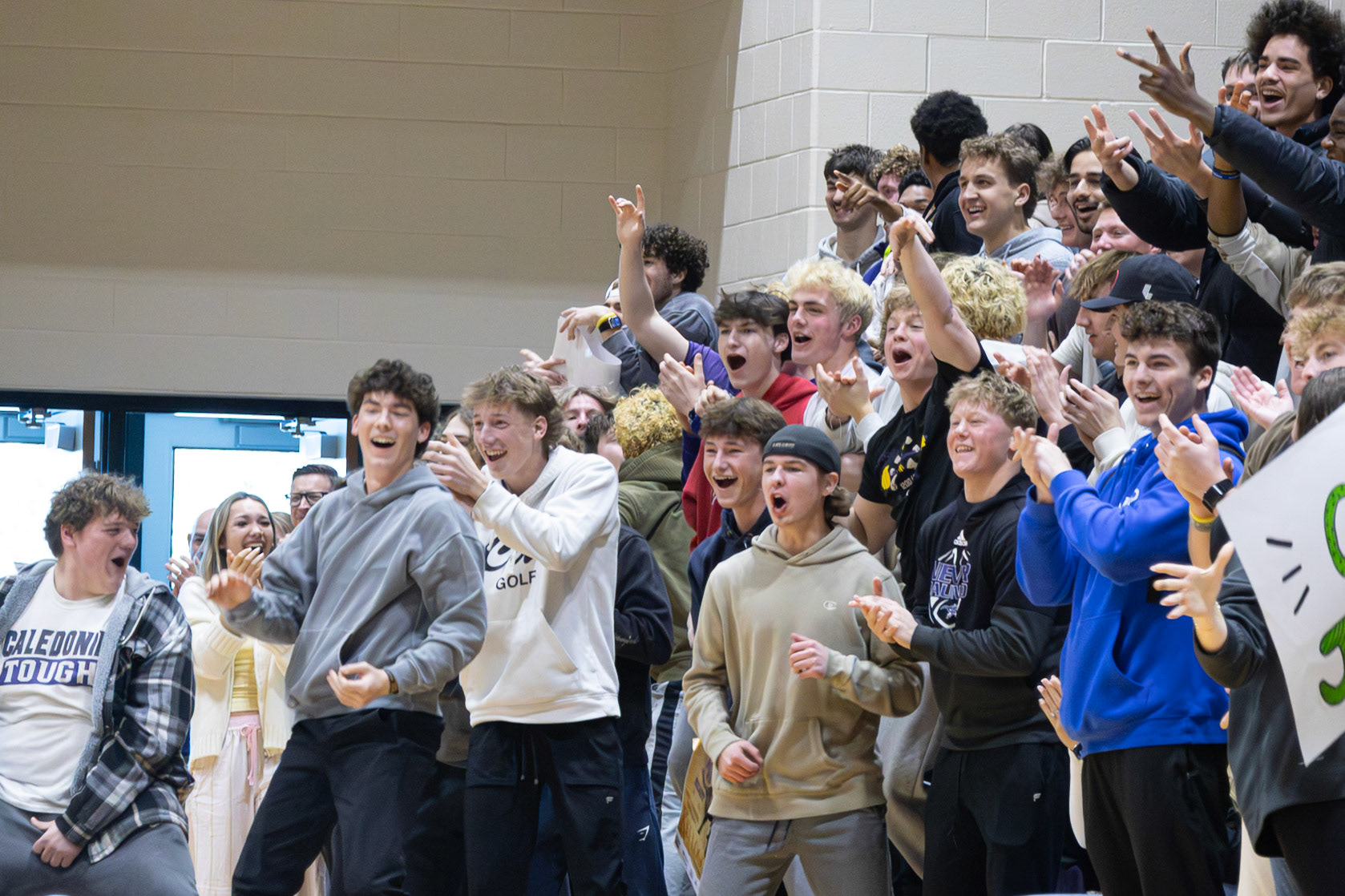 The senior boys rush onto the court with excitement after a Caledonia player sinks a basket. (Photo by Avarey Lippert)