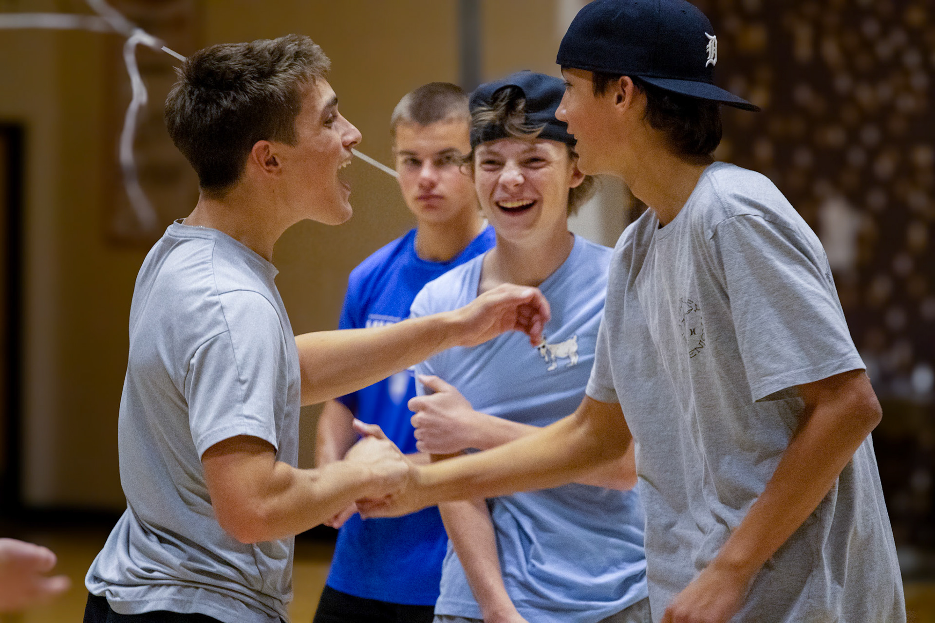 Celebrating a victory Gaige Allen and Miles Fynewever share a passionate handshake as they defeat the opposing teams in a game of 4 way volleyball. (Photo by Ella Grace Wickens)