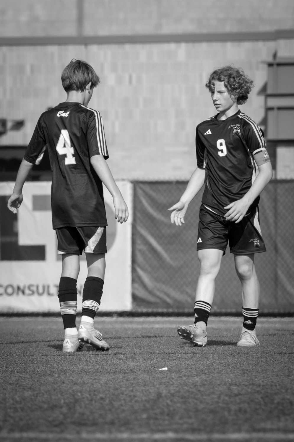 STRENGTH IN THE SMALL THINGS  Built on trust, every little win shared by Liam Dunlop and Bryce Mitchell drives the team forward against the Byron Center Bulldogs. (Photo by Avery Hitsman)