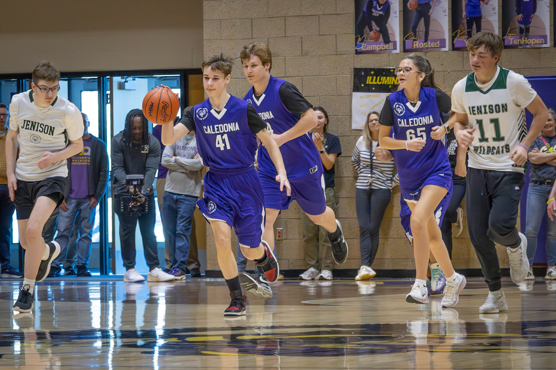 After stealing the ball from a Jenison player, Kaden Rosted races down the court, looking to even the score. (Photo by Abby Skibinski)