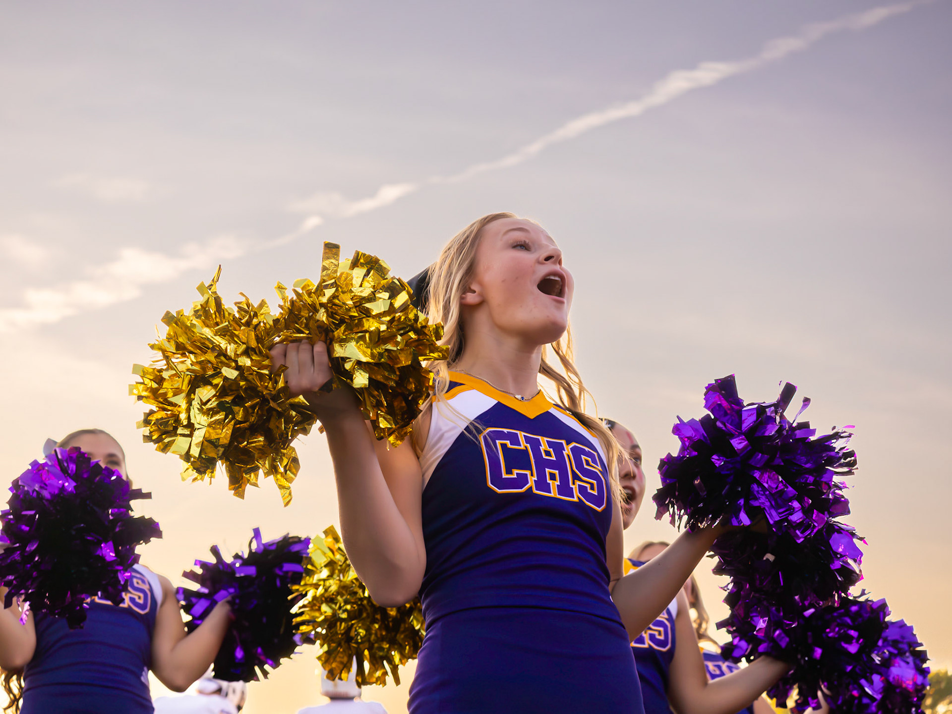 Mid-routine at the Hudsonville game, Alyssa Jernigan brings the energy and enthusiasm that light up every cheer performance. (Photo by Lillian Jackson)