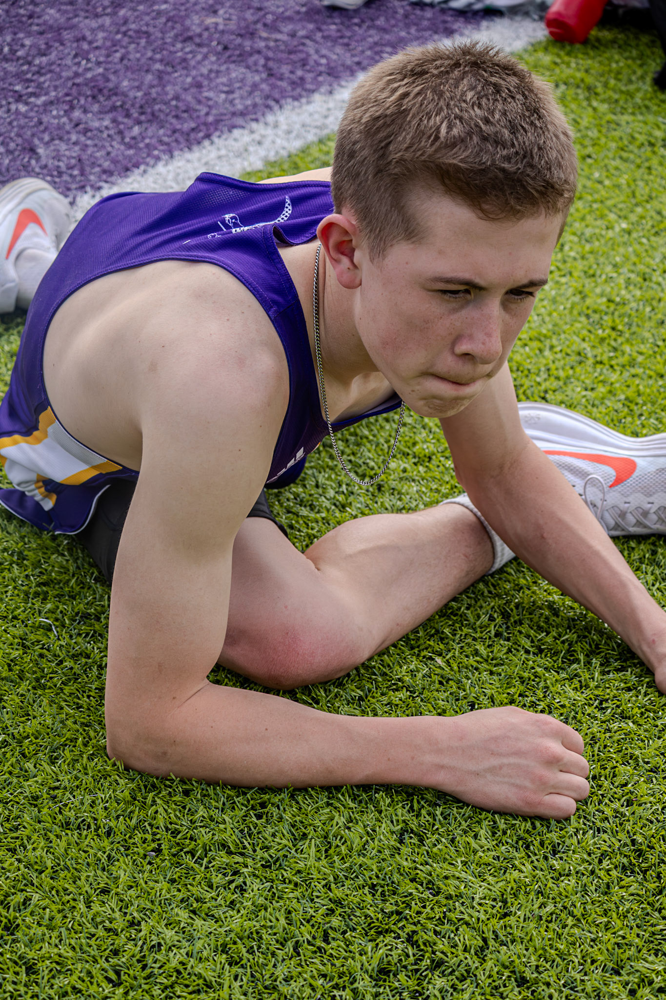 Grady Smith streches before his 1600m race to avoid any injuries. (Photo by Adi Malvankar)