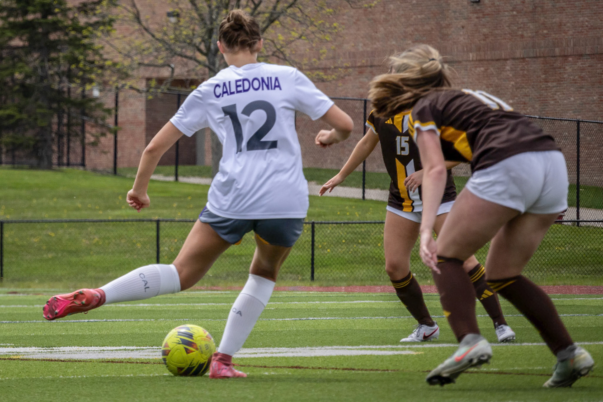 Olivia Foster passes the ball through the defenders. (Photo by Leah Hileman)