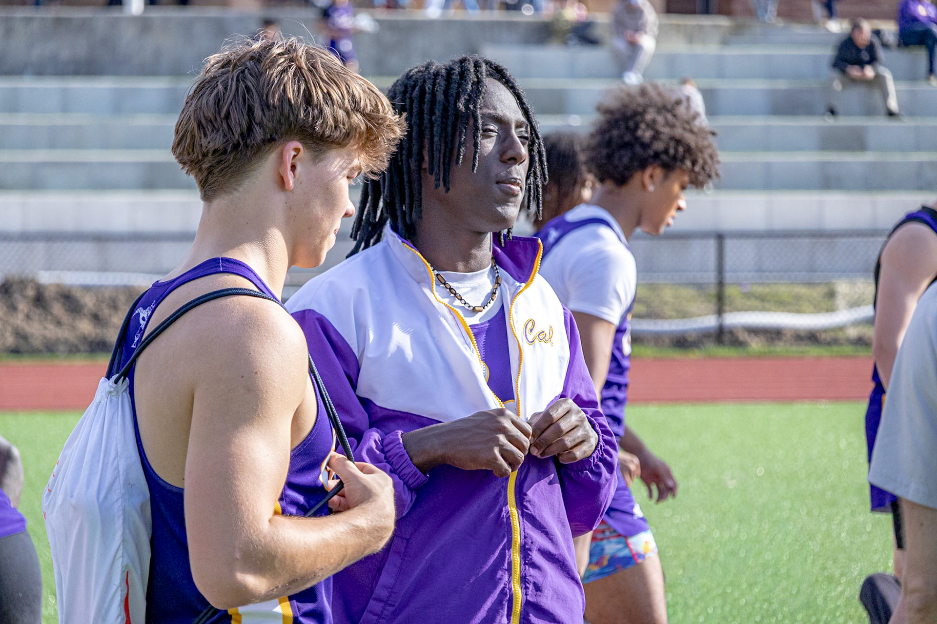 Levi Dorband and Conner Meyers chat in between events at the track meet. (Photo by Abigail Douglass)