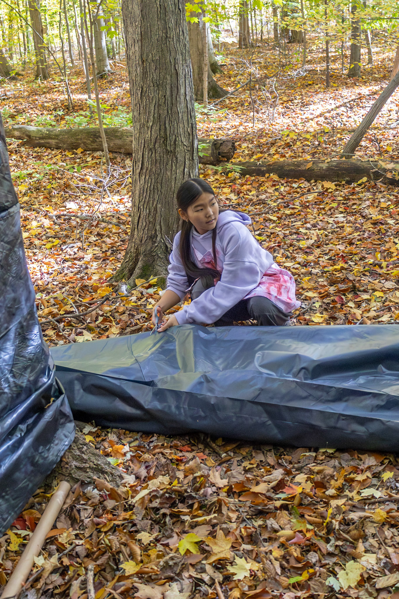Junior Vanessa Schram sets up tarps and “body bags” to get her Fright Night room ready for all the scares. (Photo by Madelynn Pittman)