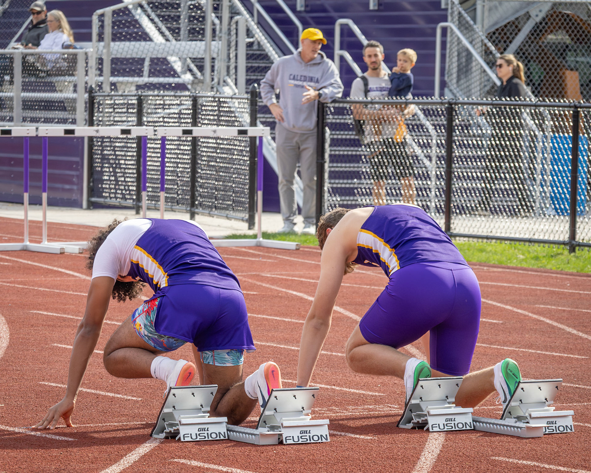 Anthony McGruder and Aiden Hager are set and ready to run the 100 meter hurdeles. (Photo by Emma Garza)