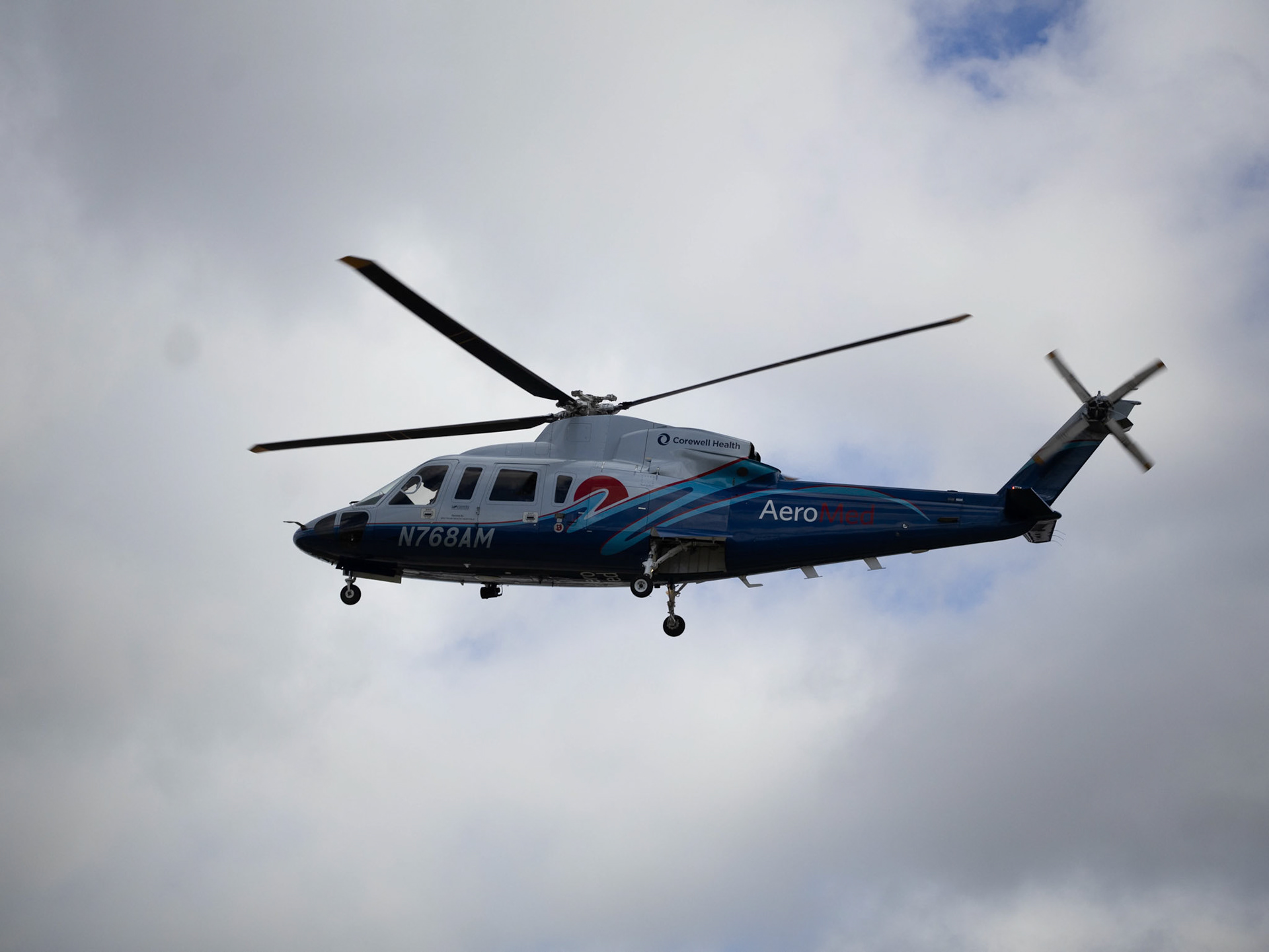 A helicopter descends into the south campus parking lot carrying a safety response team to reenact a deadly crash during the Distracted Driving Assembly for juniors at Caledonia High School. (Photo by Ella-Grace Wickens)