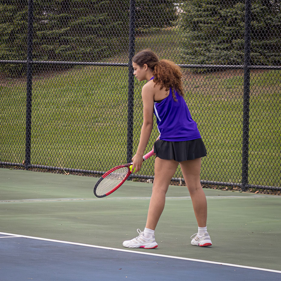 Peyton Walker sets up her serve during a match against Mona Shores, calling “30–love” to designate her team’s advantage. (Photo by Abby Skibinski).