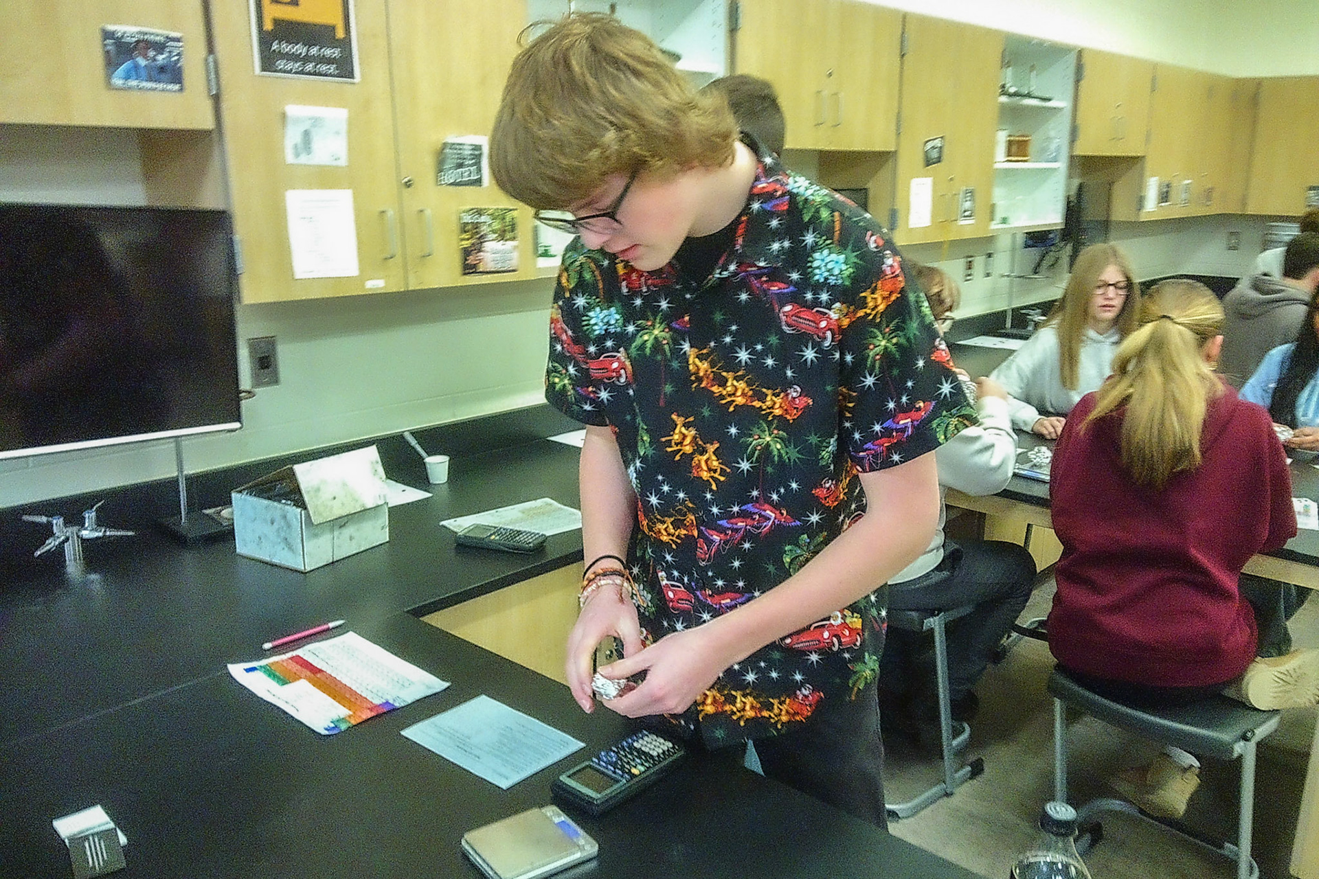 Jackson Jakel is double checking the mass of the aluminum foil before he asks Mrs. Cook to check it. (Photo by Justin Harper)