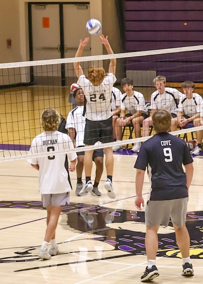 Grant Feldpausch goes up to bump the ball over the net to the opposing seniors. (Photo by Abigail Tava)