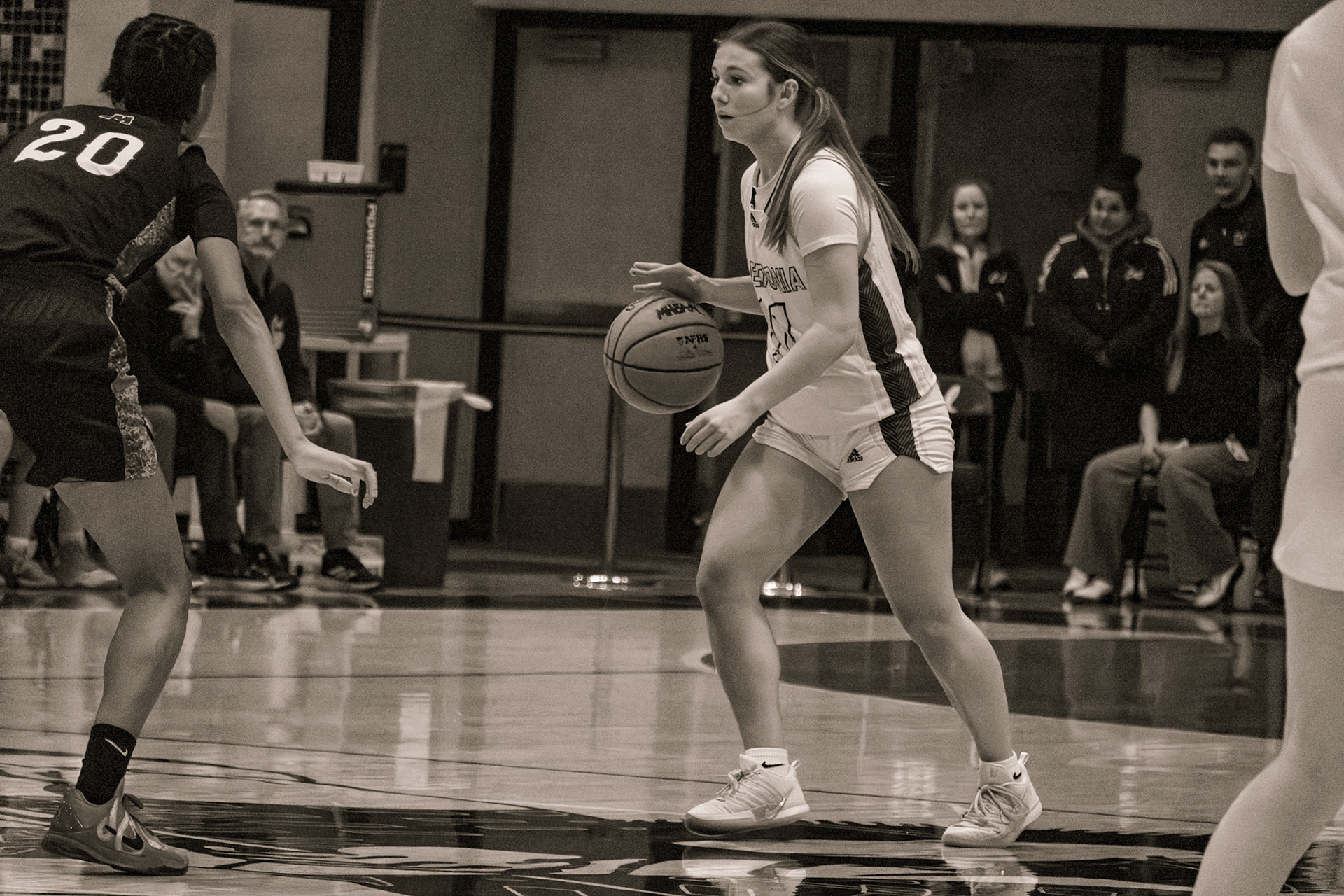 Baylee DeVries holds her ground with the ball, standing strong as two defenders close in and she looks for her next move.(Photo by Ava LaBine)