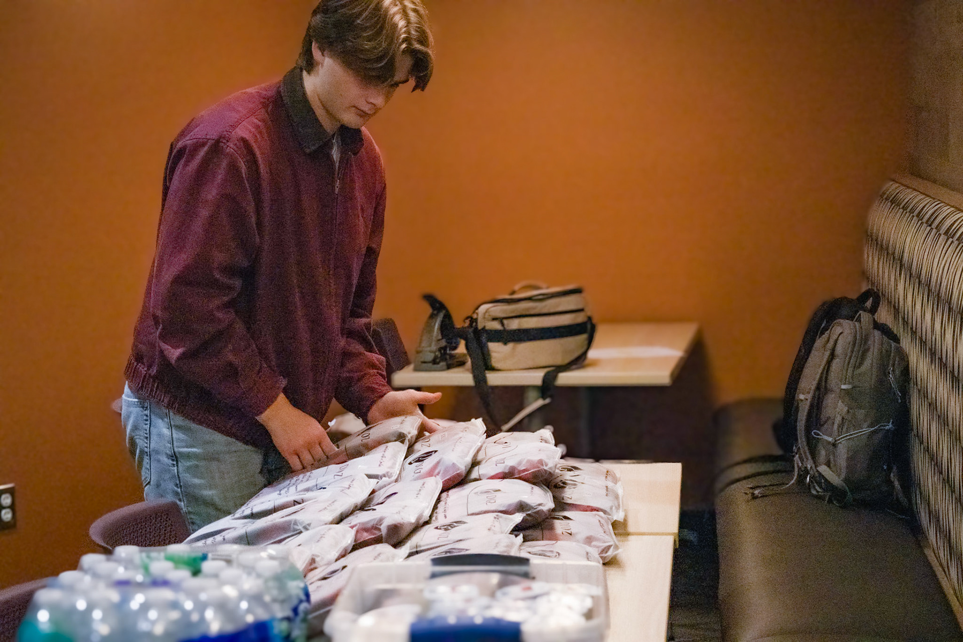 Senior Cole Nyman organizing the pajama pants donnors get after they donate there blood. (Photo by Tana Coates)