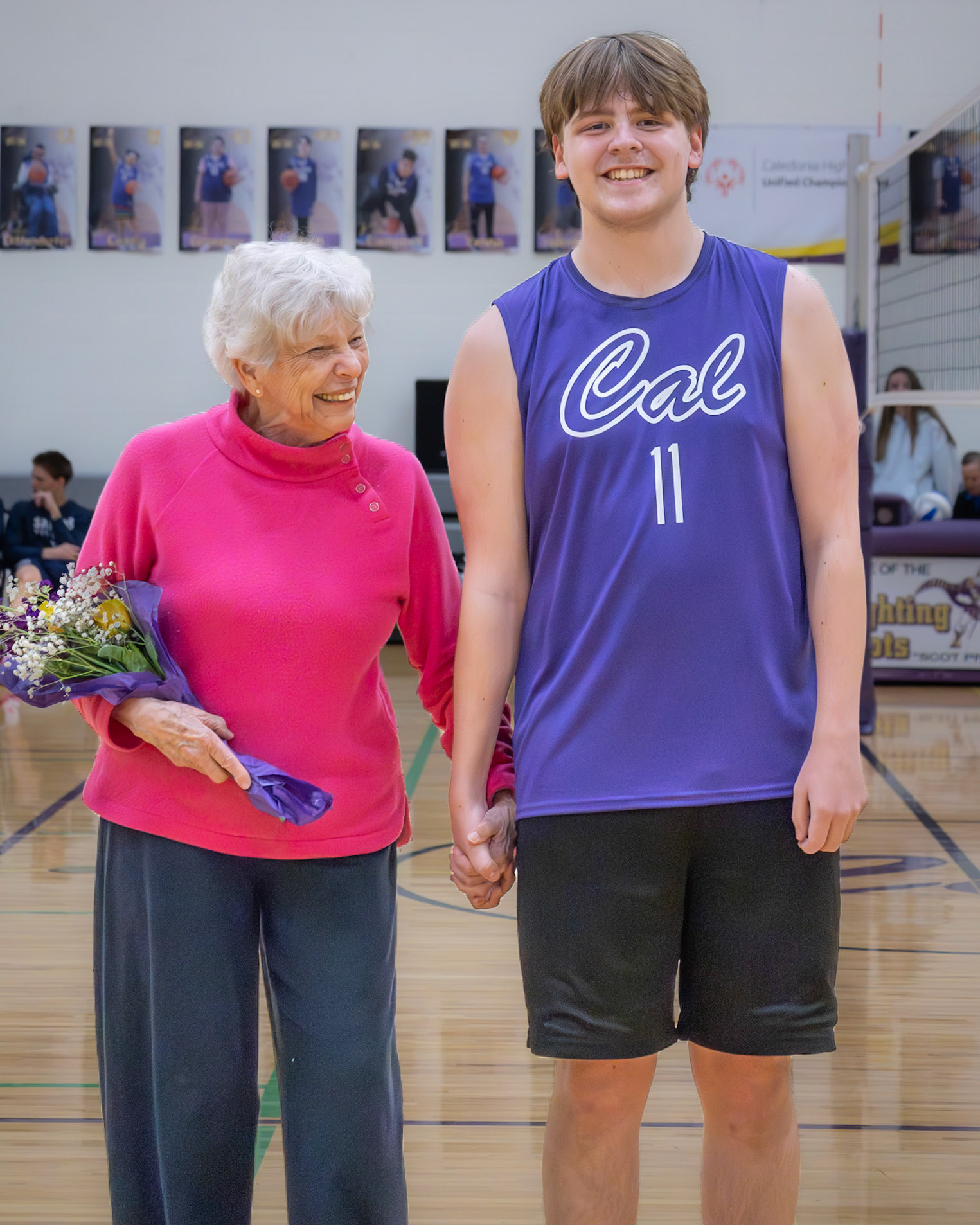 Jaren King smiles happily with his grandma hand in hand at Senior Night. (Photo by Keira Marshall)