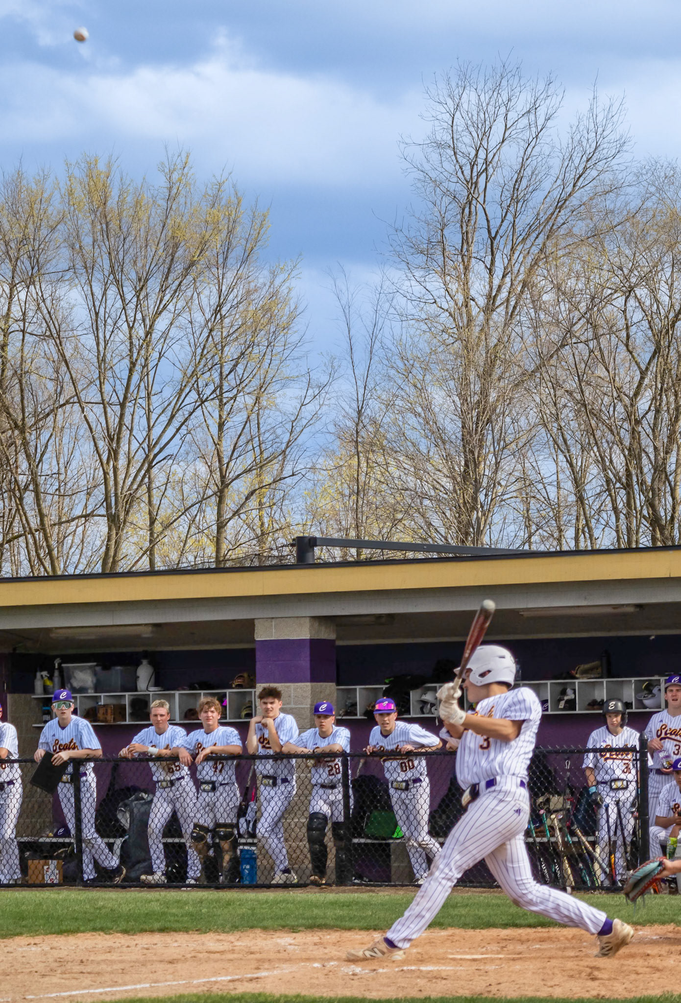 Jimmy Holmes drives a fastball into play and sprints all the way to third base. (Photo by Lilly Myers)