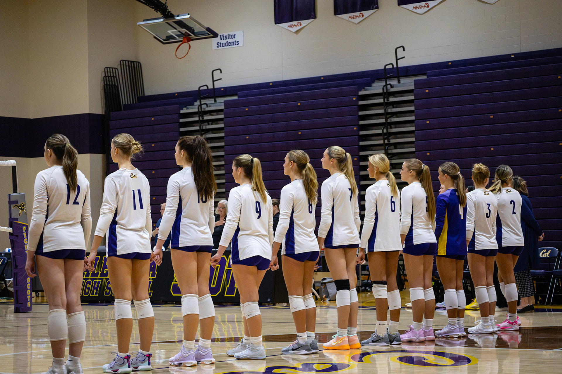 Varsity Volleyball shares a moment of unity and pride for our country before their game. (Photo by Khloe Lowande)
