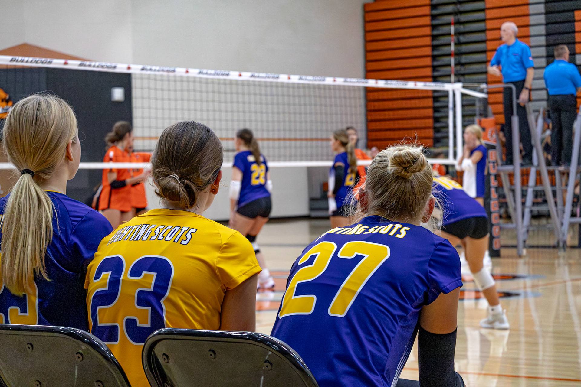 Freshman volleyball players support their teammates from the sideline during a match. (Photo by Elsha Bytwork)