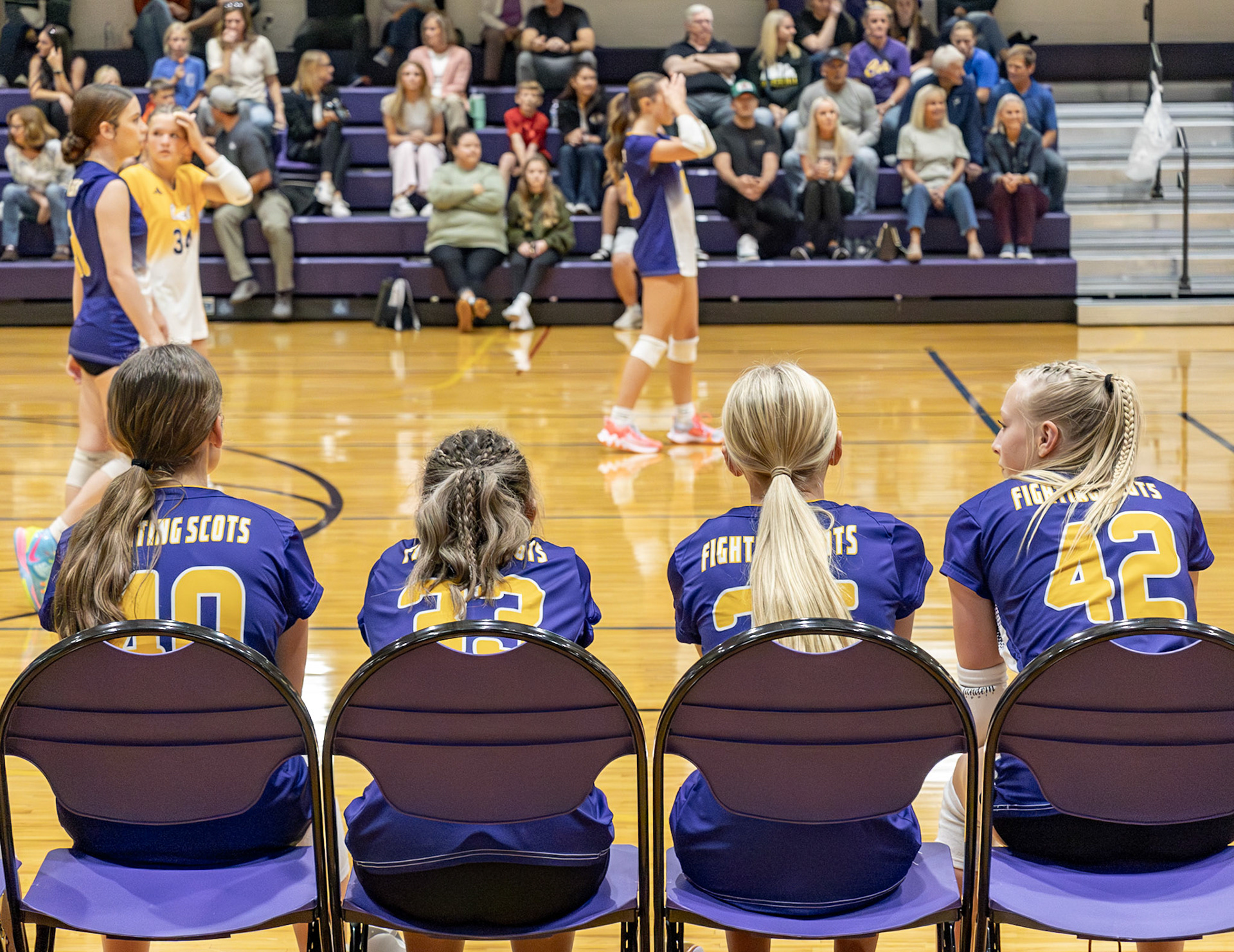 STRATEGIZE These four watch the freshman girls volleyball team in action, studying the game and observing strategy.(Photo by Elsha Bytwork)