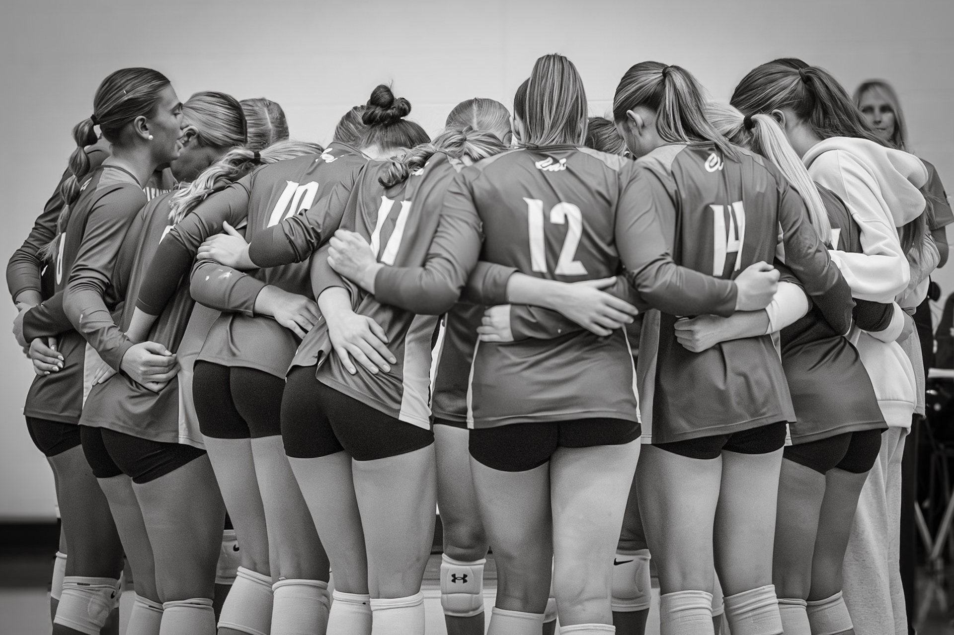 HUDDLE UP  The varsity volleyball coaches share some last minute advice before sending the team to the court. (Photo by Ella-Grace Wickens)