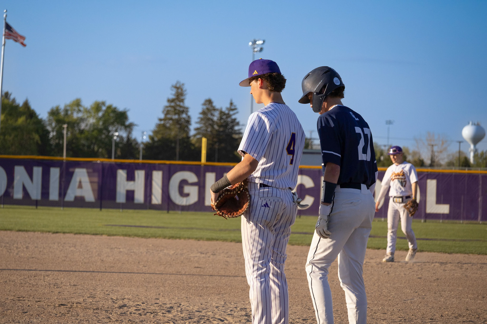 Waiting for Lincoln Snow to pitch, Gabe Trudeau stands ready at first base in case the runner attempts to steal. (Photo by Ella-Grace Wickens)