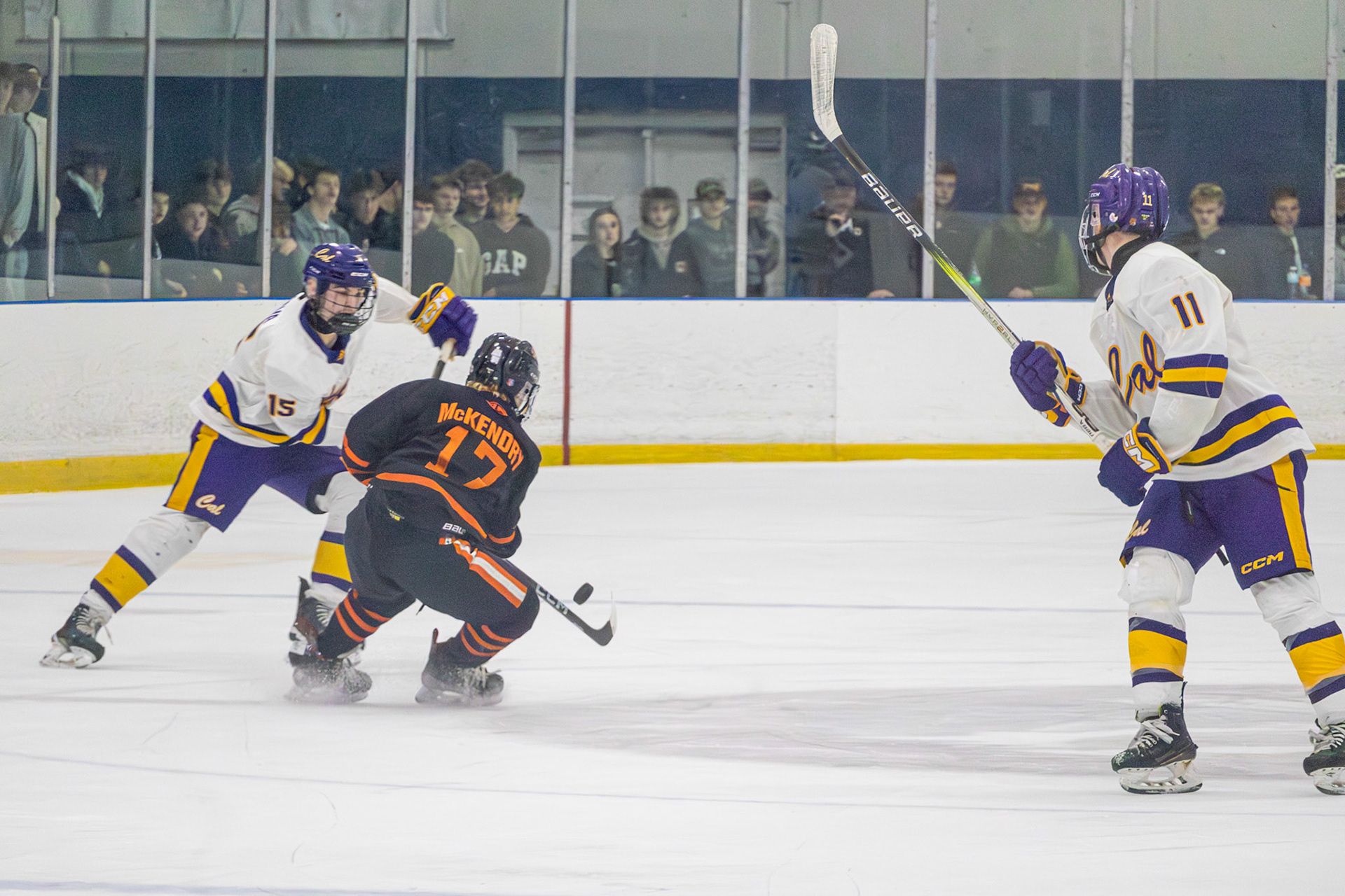 Ty Lewandowski watches the play develop as Ethan Sova knocks the puck loose. (Photo by Aaron Pyper)