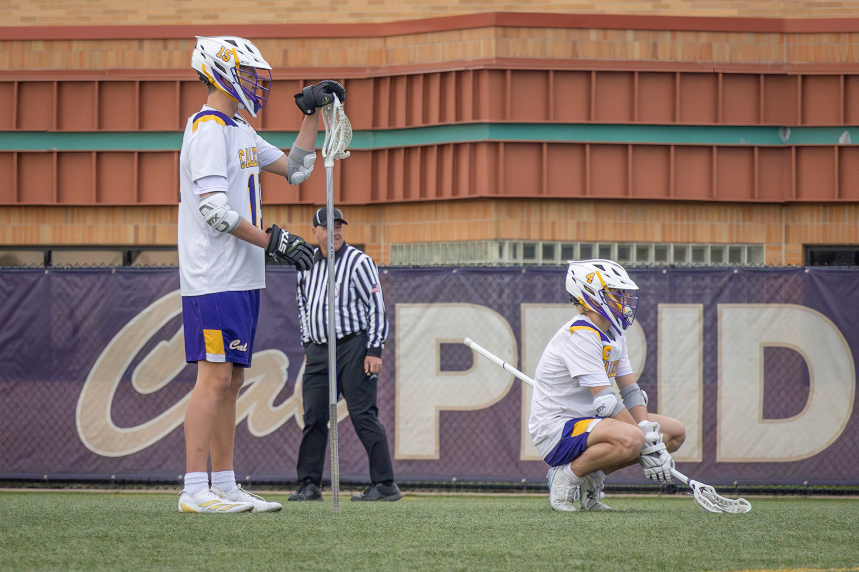 (13) Conlan Shultz, and Sam Hoag wait patiently for a hurt player to get up and to contiue the play. (Photo by Emma Garza)