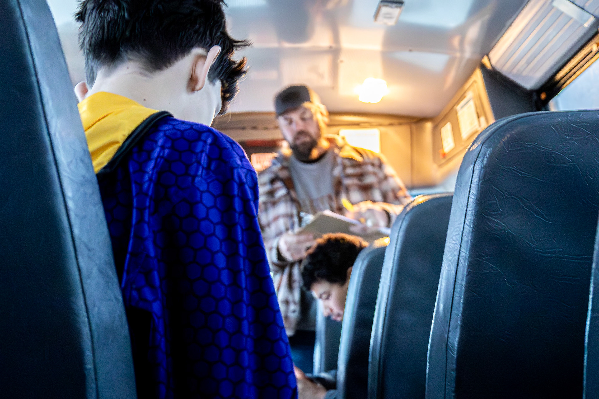Austin Bird in a moment of quiet focus on the bus as Coach Reeder takes role. (Photo by Egan Otto)