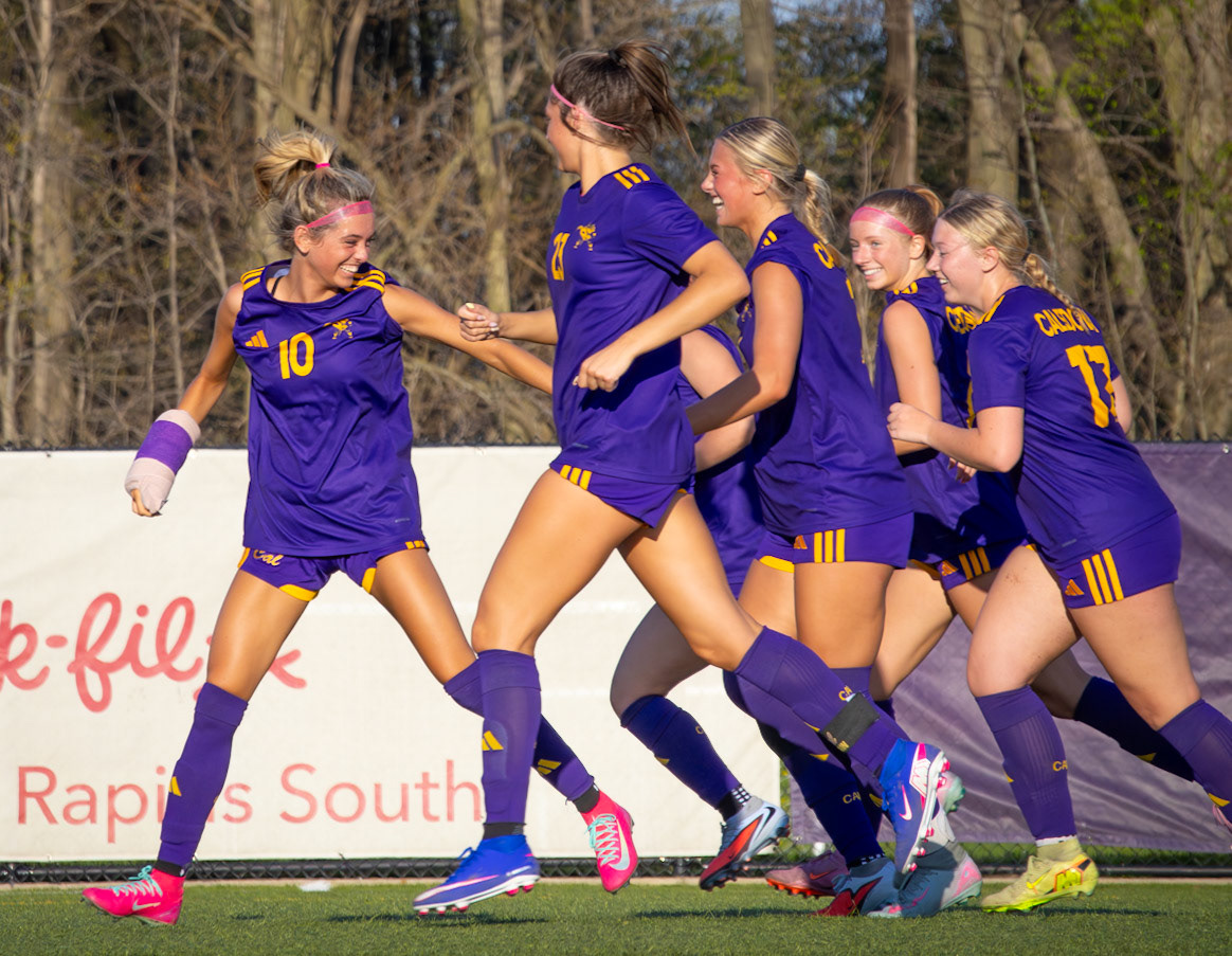 Triumphant, Maya celebrates with her team, adding to their biggest lead of the season. (Photo by Aibree Akers)